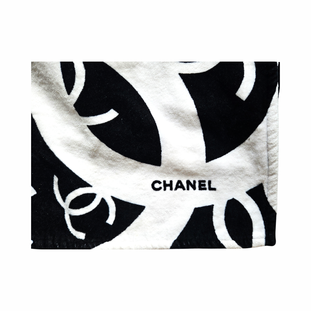 Close-up of black and white oversized CHANEL interlocking CC logo design and terry cotton texture