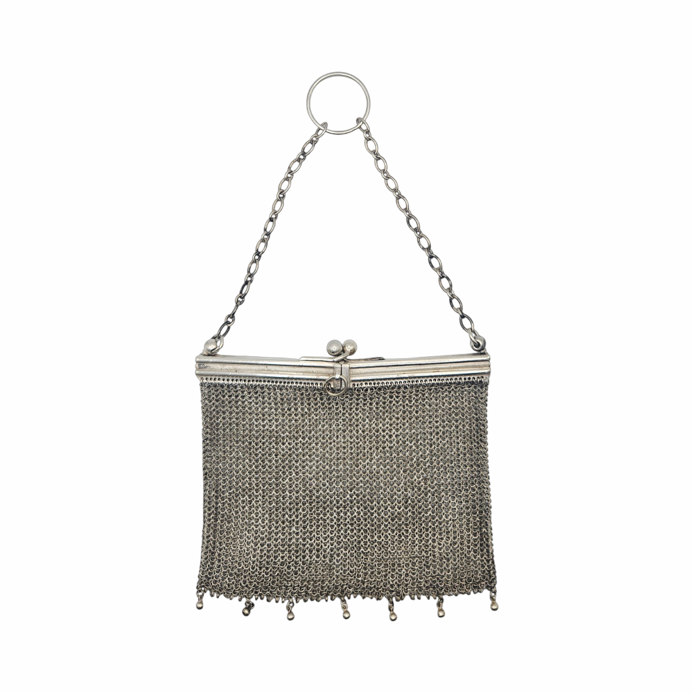 Vintage 1910s–1920s mesh purse showing flexible metal chainmail body and rigid frame