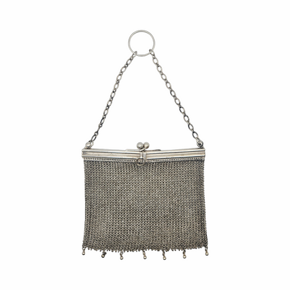 Vintage 1910s–1920s mesh purse showing flexible metal chainmail body and rigid frame