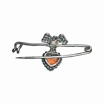 Vintage 1930s–40s sweetheart safety pin brooch with sculpted bow and dangling orange heart cabochon. Romantic vintage costume jewellery.