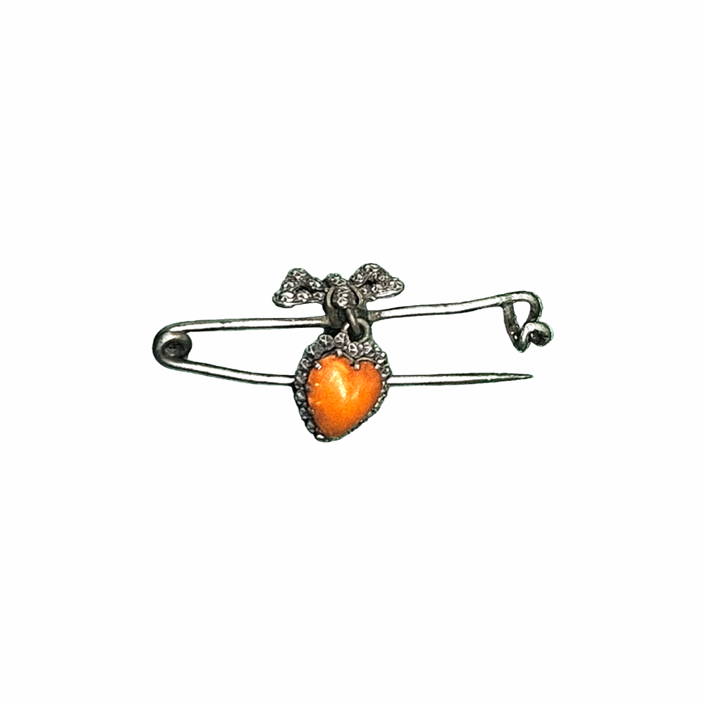 Vintage 1930s–40s sweetheart safety pin brooch with sculpted bow and dangling orange heart cabochon. Romantic vintage costume jewellery.