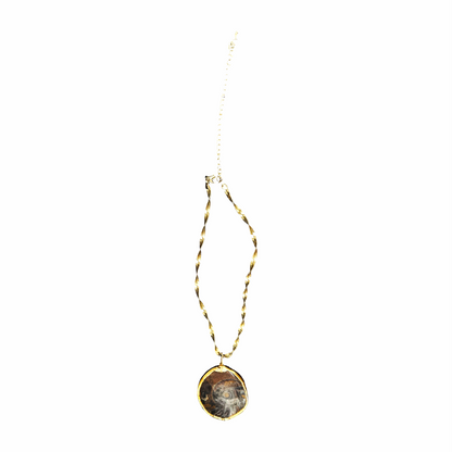 Vintage ammonite fossil pendant necklace with a polished natural spiral fossil, gold-tone surround and twisted herringbone-style chain.