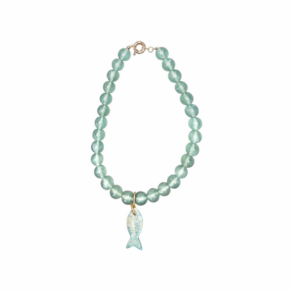 Vintage seafoam cat’s eye glass bead necklace with carved blue fish pendant, gold-tone fittings and coastal nautical styling.