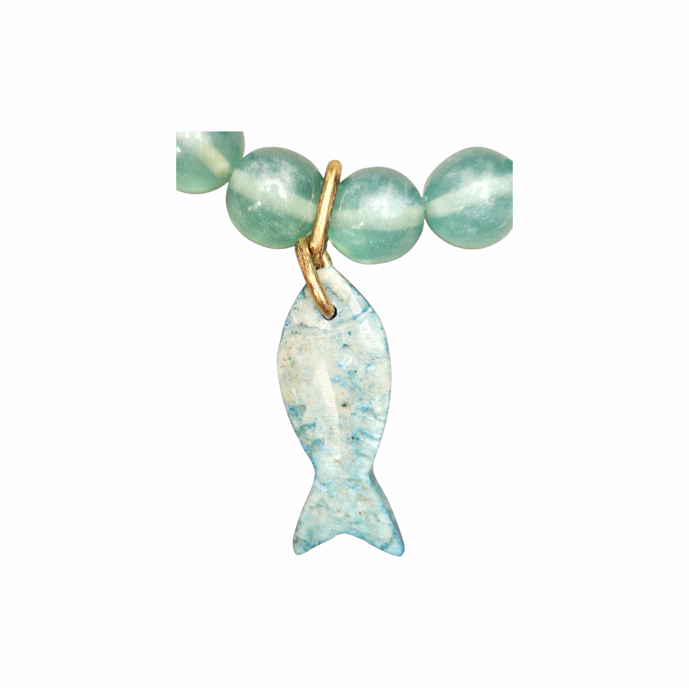 Vintage seafoam cat’s eye glass bead necklace with carved blue fish pendant, gold-tone fittings and coastal nautical styling.