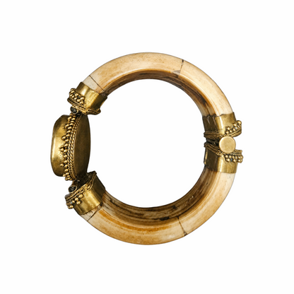 Vintage hinged statement cuff bracelet with bone-tone segments, ornate gold-tone metalwork and large smoky agate-effect cabochon. Bold tribal-inspired jewellery, circa 1980s.