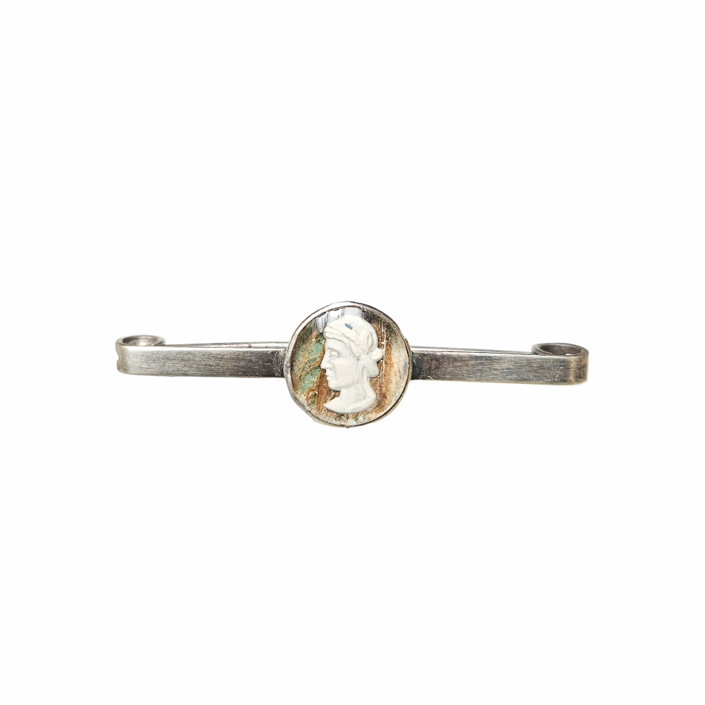 Vintage silver-tone safety pin brooch with oval Classical Renaissance-style cameo portrait medallion, aged patina and curled pin terminals.