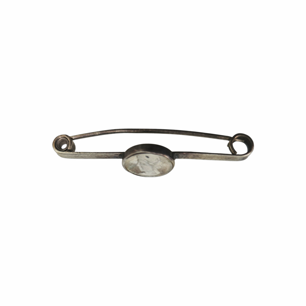 Vintage silver-tone safety pin brooch with oval Classical Renaissance-style cameo portrait medallion, aged patina and curled pin terminals.