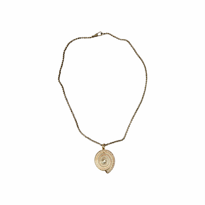Vintage Shiva eye shell spiral pendant necklace on an antiqued gold-tone chain. Natural sea-shell talisman jewellery with a delicate bohemian look.