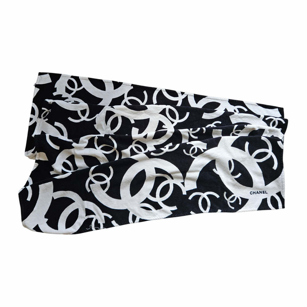 Folded CHANEL black and white oversized CC monogram terry cloth beach towel showing cotton texture