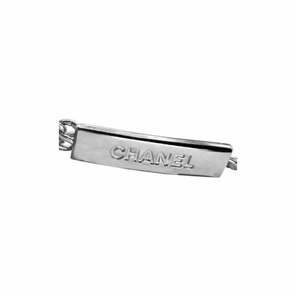 Close-up of CHANEL embossed rectangular plaque on vintage 99P silver chain belt