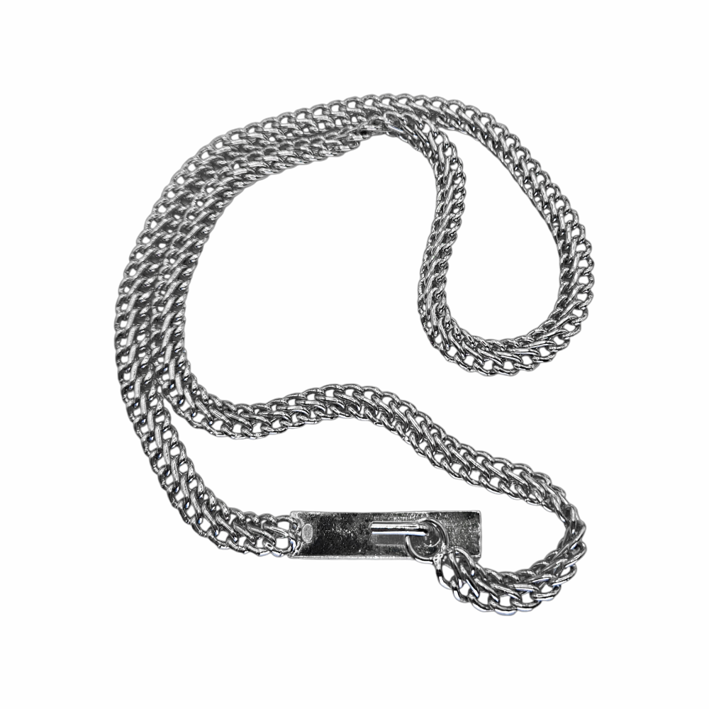 Close-up of CHANEL logo plaque and silver chain links on vintage 1999 belt