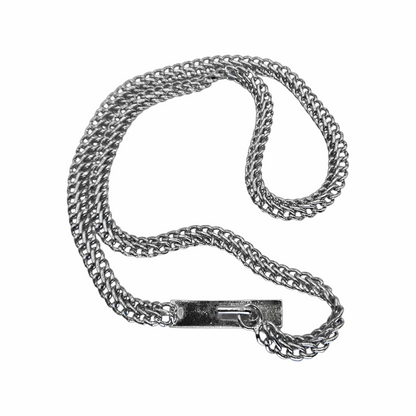 Close-up of CHANEL logo plaque and silver chain links on vintage 1999 belt