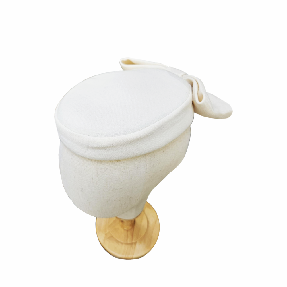 Vintage 1950s-60s ivory cocktail hat with an oversized bow and elegant mid-century silhouette. A distinctive occasion hat for weddings, races and formal events.