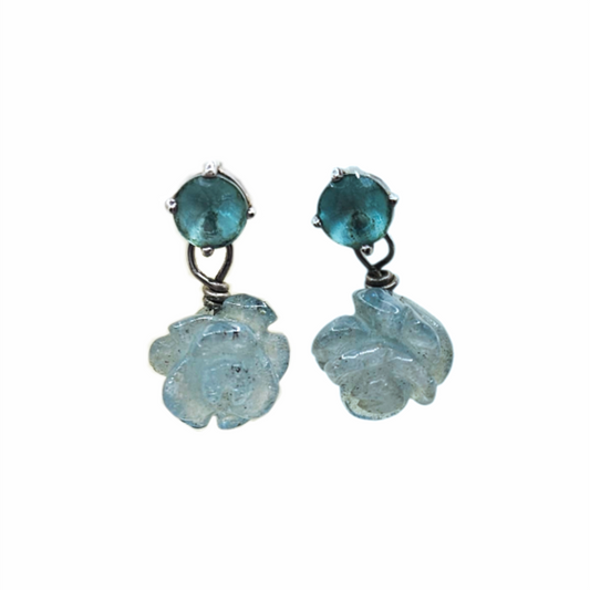 Blue glass floral drop earrings with dark teal cabochon studs and carved translucent pale-blue flower pendants