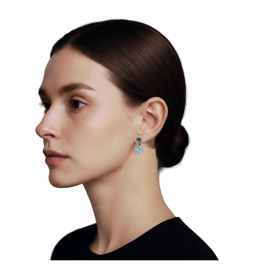Model Wearing Blue glass floral drop earrings with dark teal cabochon studs and carved translucent pale-blue flower pendants