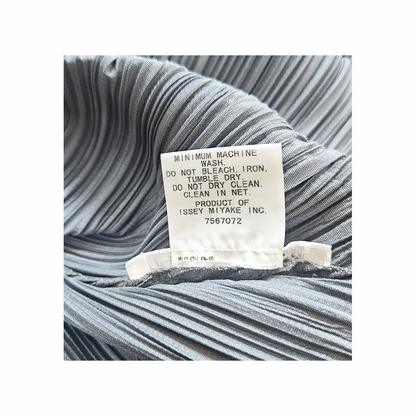 Original Pleats Please Issey Miyake garment care label showing washing instructions