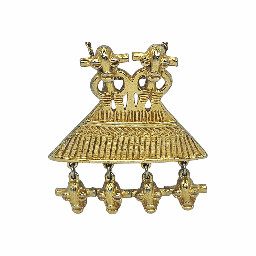 1980s Judith Leiber gold-plated figural pendant necklace with articulated drops and West African-inspired - likely inspired by senufo amulettes - sculptural detailing. Signed vintage designer jewellery.