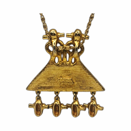 1980s Judith Leiber gold-plated figural pendant necklace with articulated drops and West African-inspired - likely inspired by senufo amulettes - sculptural detailing. Signed vintage designer jewellery.