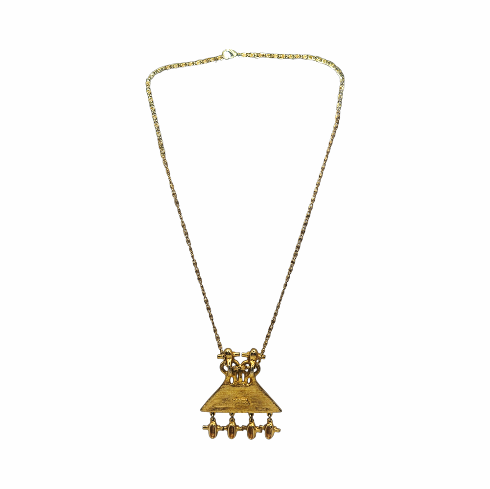 1980s Judith Leiber gold-plated figural pendant necklace with articulated drops and West African-inspired - likely inspired by senufo amulettes - sculptural detailing. Signed vintage designer jewellery.