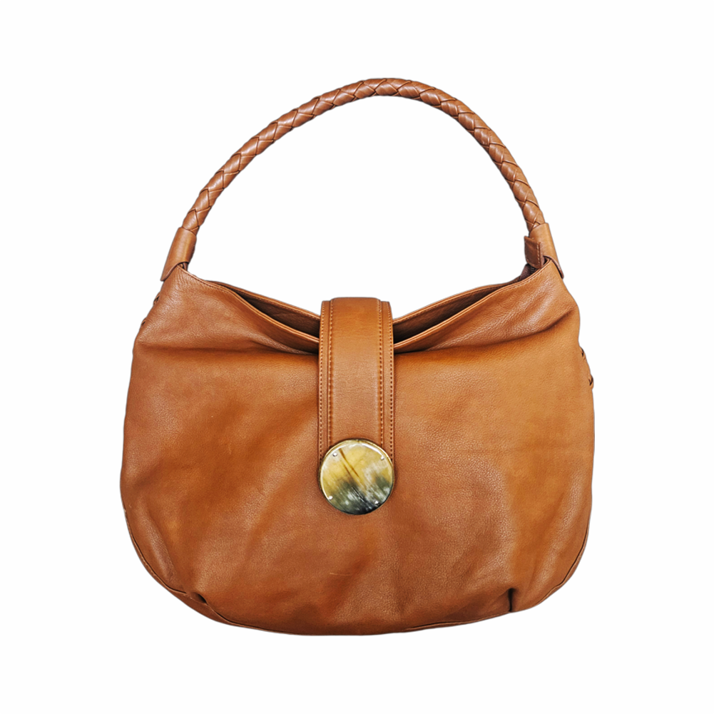 a Kenall tan leather hobo bag with braided handle, horn-style disc fastening and hand-laced detailing. A distinctive cognac leather shoulder bag.