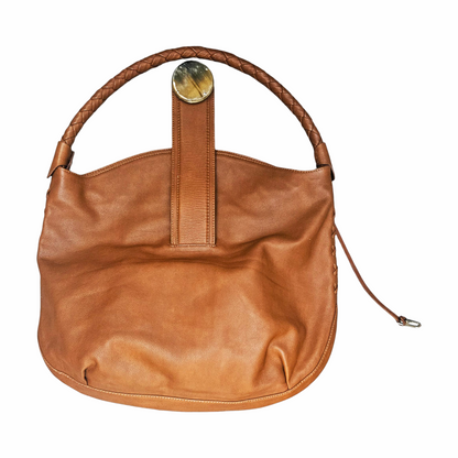 Kenall tan leather hobo bag with braided handle, horn-style disc fastening and hand-laced detailing. A distinctive cognac leather shoulder bag.