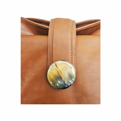Kenall tan leather hobo bag with braided handle, horn-style disc fastening and hand-laced detailing. A distinctive cognac leather shoulder bag.