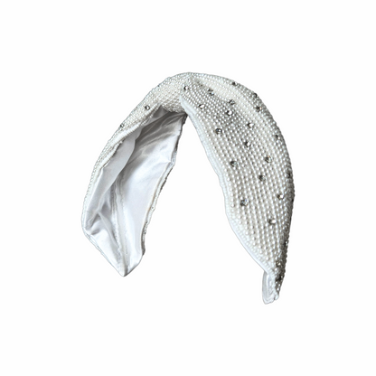 White faux pearl and crystal bow headband with padded construction and satin lining, ideal for bridal and occasion wear.