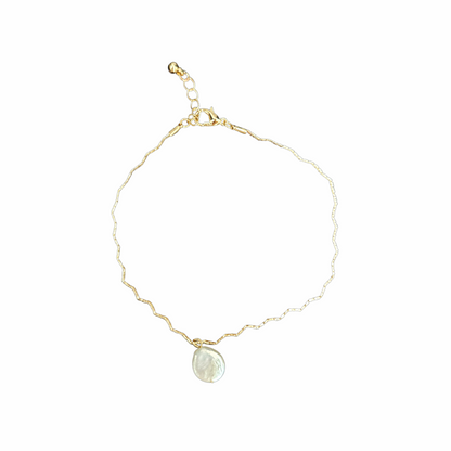 Gold-tone short necklace with an irregular mother-of-pearl disc pendant, textured chain and adjustable lobster-clasp fastening.