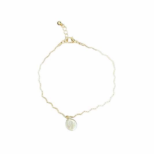 Gold-tone short necklace with an irregular mother-of-pearl disc pendant, textured chain and adjustable lobster-clasp fastening.