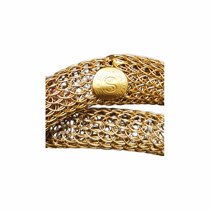Close-up of signed Sarah Cavender Metalworks round clasp on gold mesh bracelet