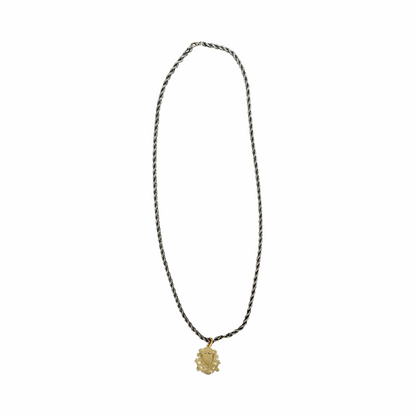 Vintage India silver heraldic shield pendant on twisted rope chain with pierced foliate detailing and aged mixed-metal finish.
