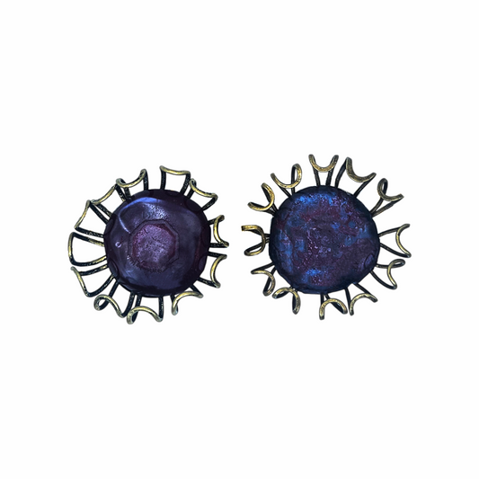 Oversized artisan brutalist vintage clip-on earrings with purple glass centres and sculptural brass-tone cage detailing, approx. 5 cm diameter.